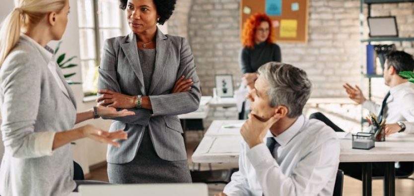 female-african-american-entrepreneur-her-colleagues-communicating-business-meeting-modern-office-there-are-people-background